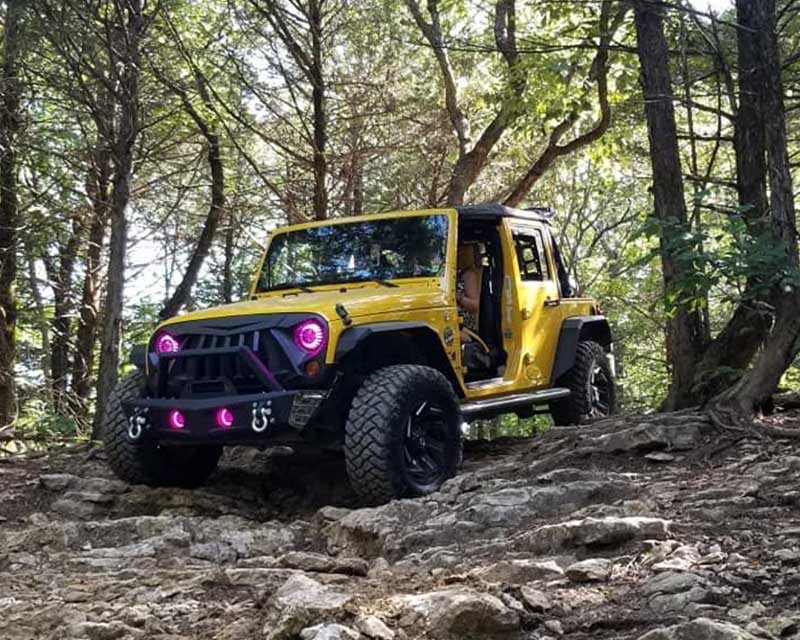 Yellow jeep wrangler with pink lights