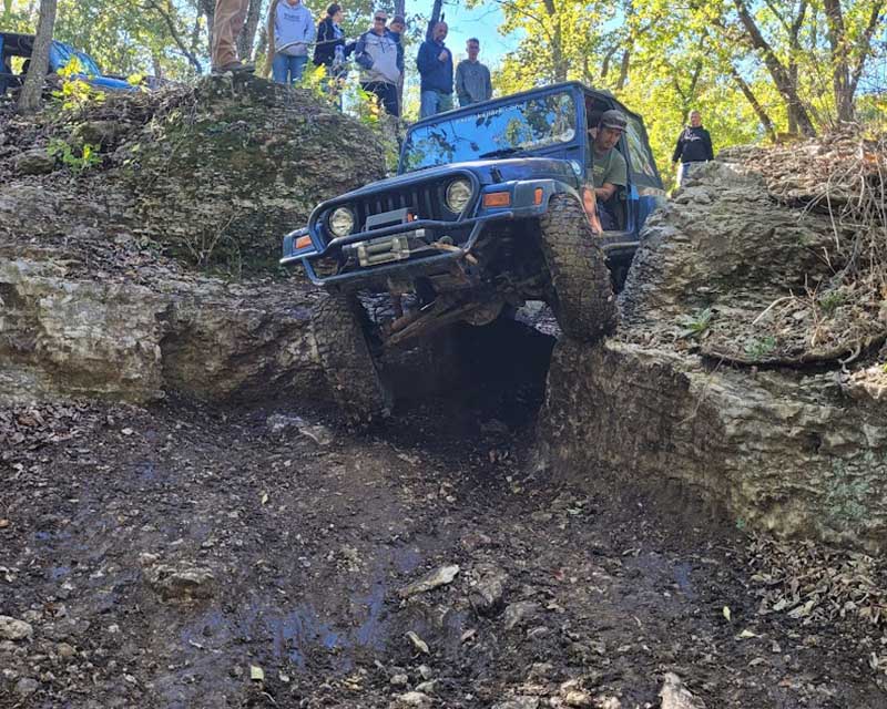 Jeep driving through narrow rock section