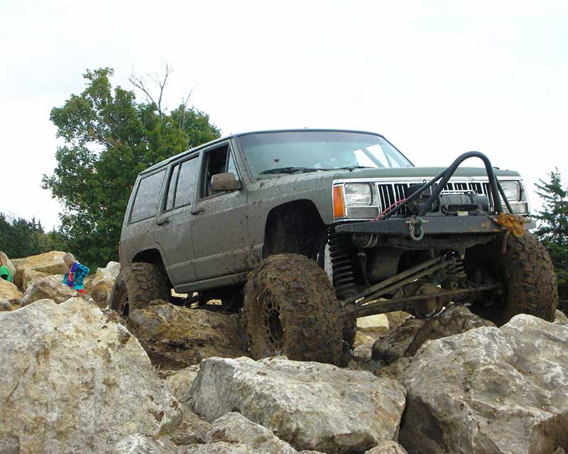 Off road Jeep Cherokee driving over boulders