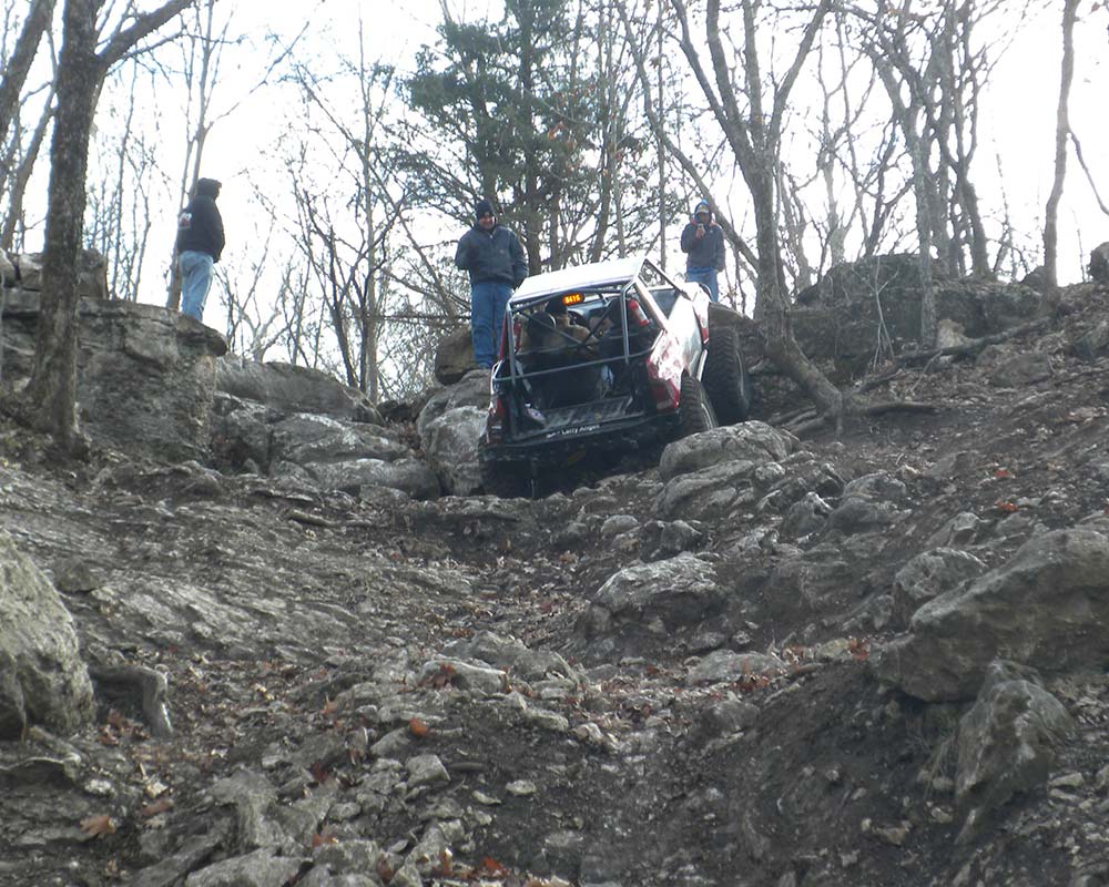 Off-road truck diving up steep rocky trail